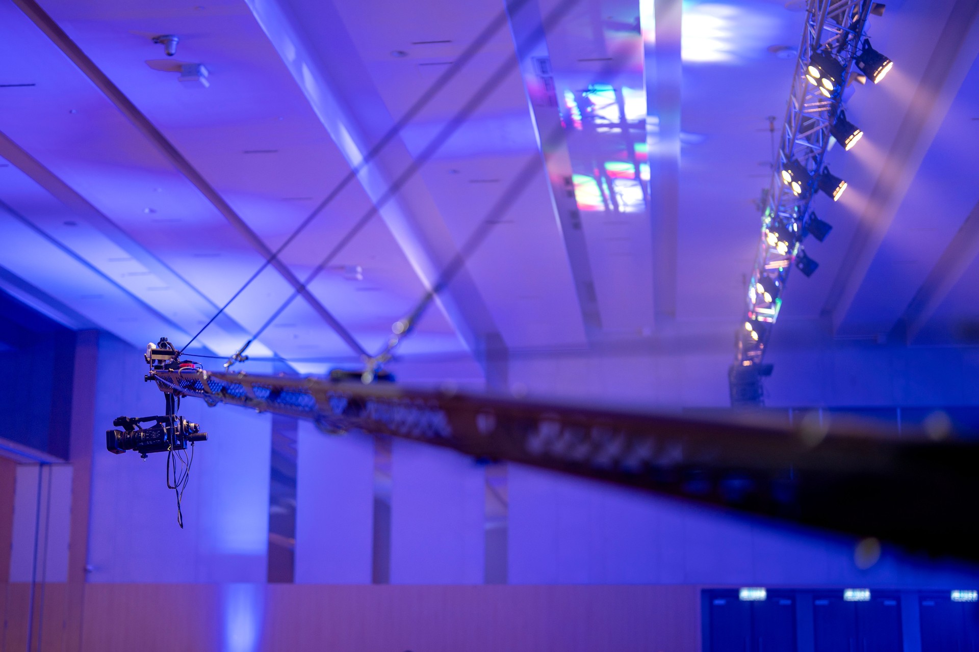 A camera recording on a crane during production at a ballroom event